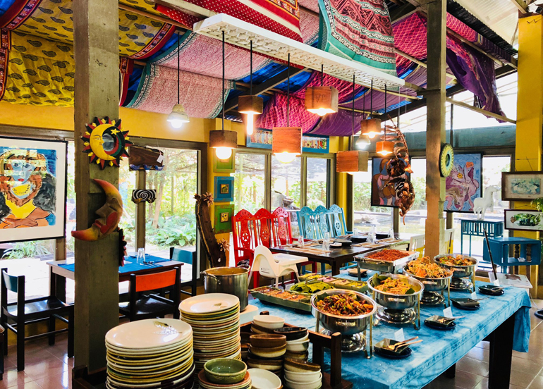 Vibrantly-colored Crescent Moon Cafe Interior with a buffet table