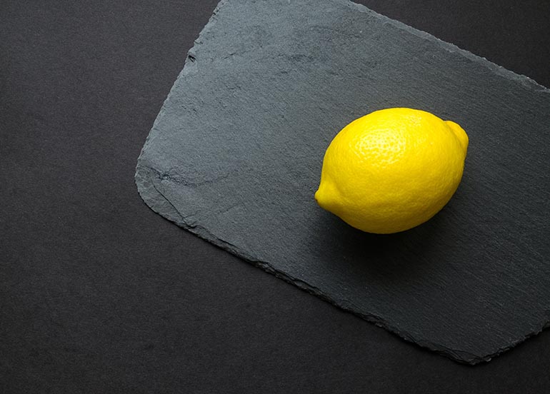 lemon-on-black-cutting-board